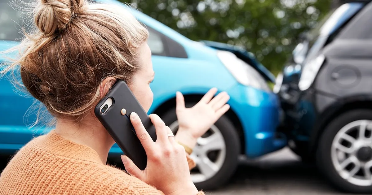 Women on a phone - looking at a car crash